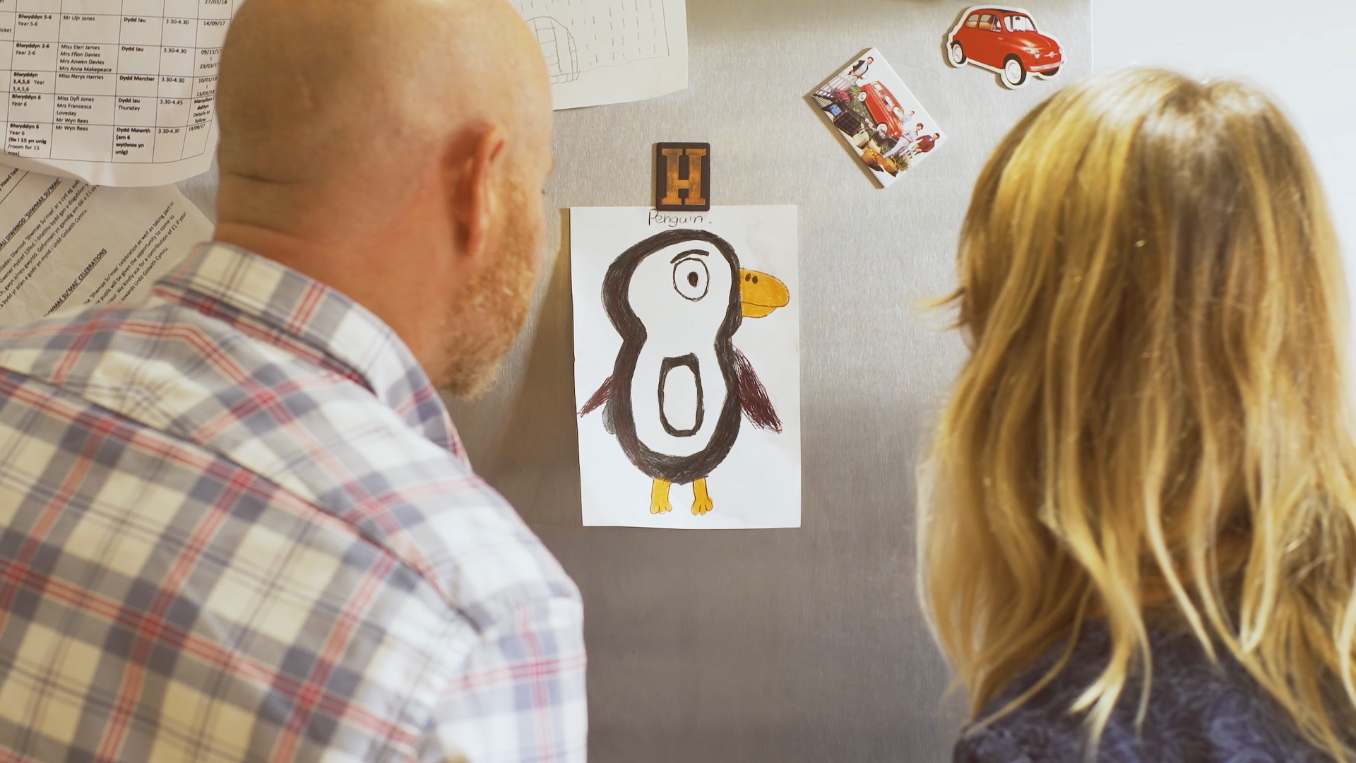 Parents looking at penguin drawing