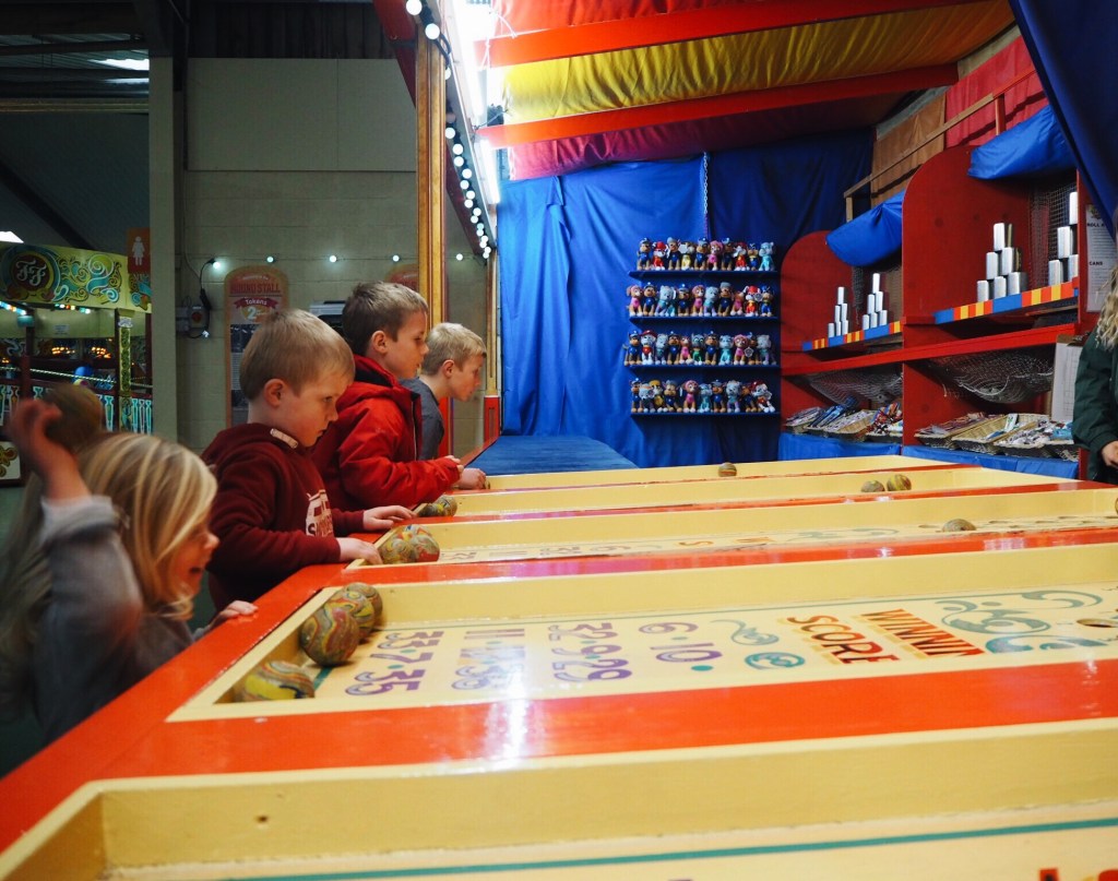 Children playing Folly Farm side stalls