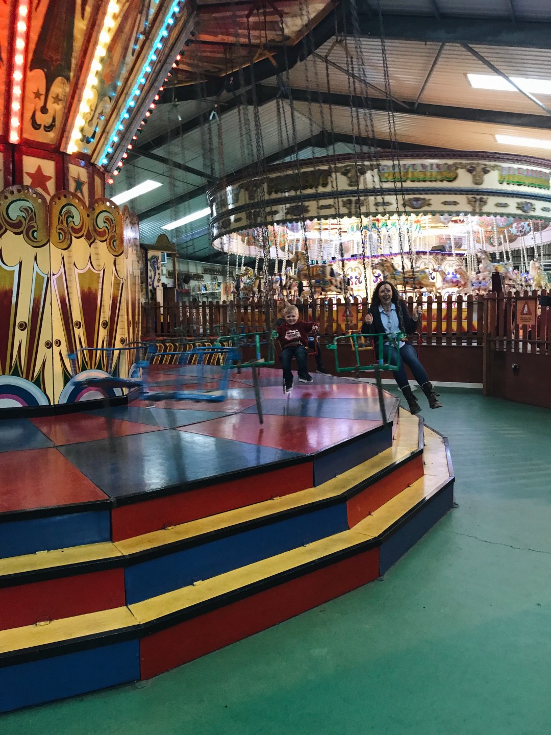 Mum and boy on chair-o-plane ride at Folly Farm