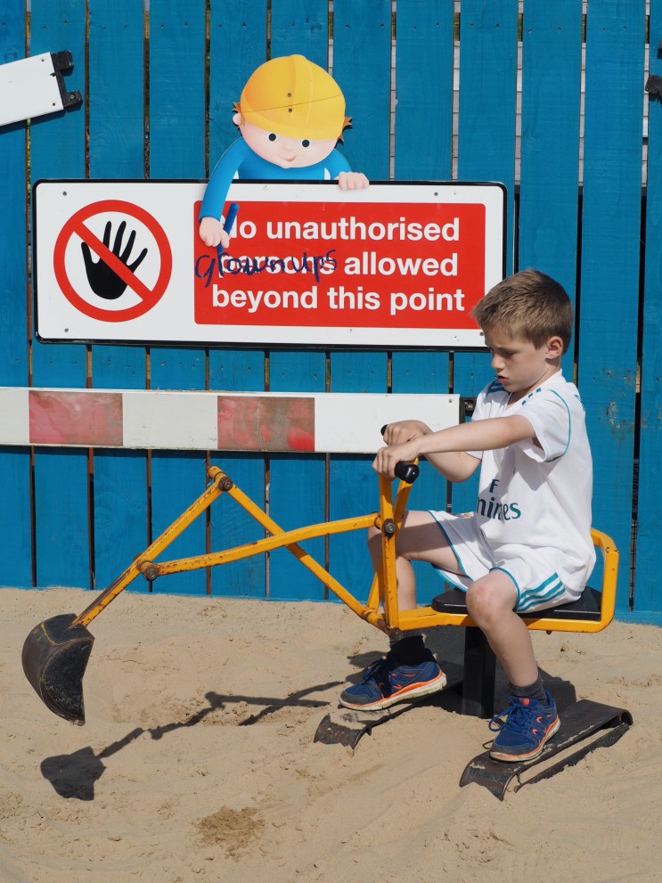 Boy on sandpit digger at Folly Farm