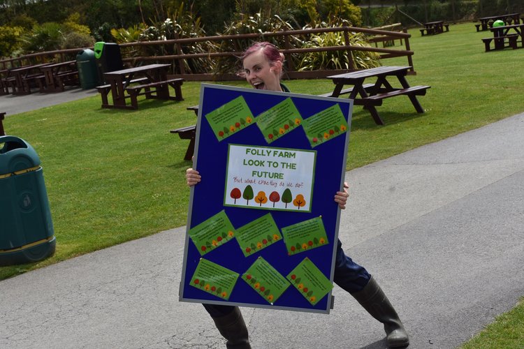 Zoo keeper with environmental pledge board