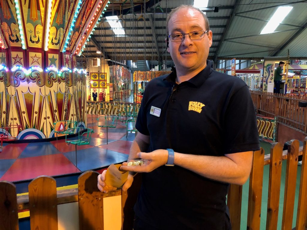 Man with fairground tokens